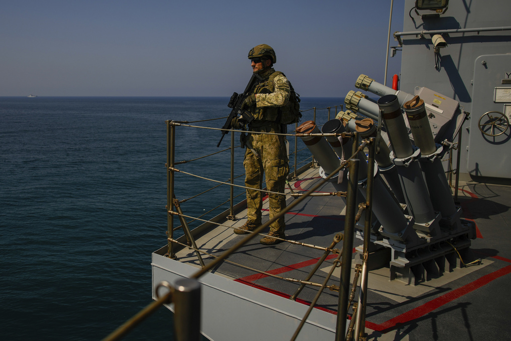 FILE - A Turkish army soldier stands guard on one of two military ships sailing in the Mediterranean Sea, heading from the port of Mersin, Turkey, to the port of Beirut to deliver human aid and evacuate Turkish citizens from Lebanon, Wednesday, Oct. 9, 2024. (AP Photo/Emrah Gurel, File)