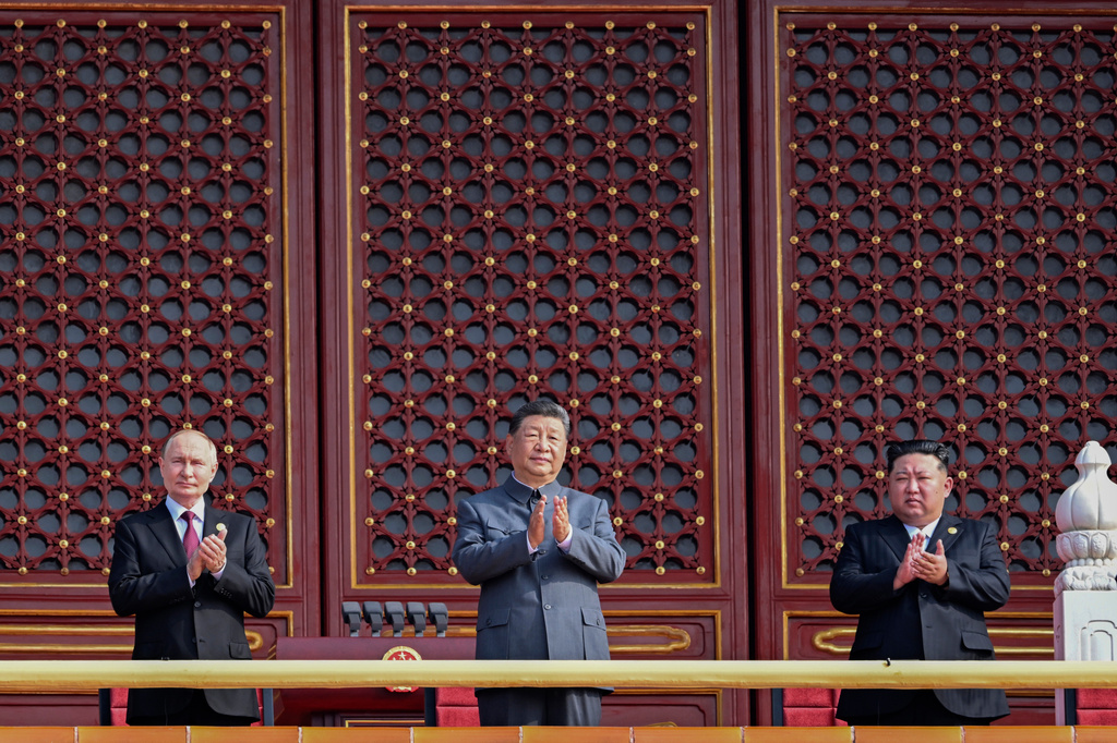 FILE - In this photo released by Xinhua News Agency, from left Russian President Vladimir Putin, Chinese President Xi Jinping and North Korean leader Kim Jong Un applaud from Tiananmen Gate as they attend a military parade marking the 80th anniversary of the end of World War II at Tiananmen Square in Beijing on Sept. 3, 2025. (Rao Aimin/Xinhua via AP, File)