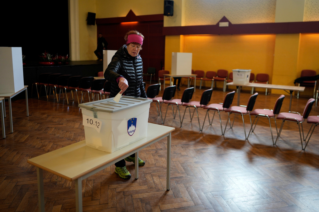 A voter casts her ballot at a polling station during the referendum on assisted dying for terminally ill patients, in Domzale, Slovenia, Sunday, Nov. 23, 2025. (AP Photo/Darko Bandic)