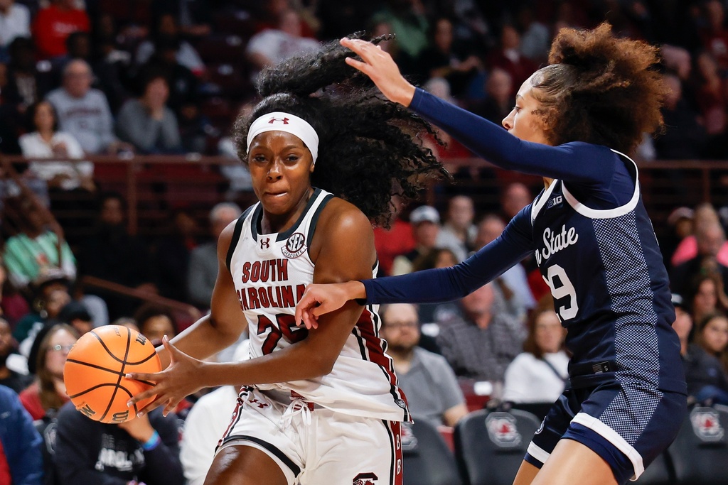 South Carolina guard Raven Johnson, left, drives to the basket against Penn State guard Tea Cleante, right, during the first half of an NCAA college basketball game in Columbia, S.C., Sunday, Dec. 14, 2025. (AP Photo/Nell Redmond)