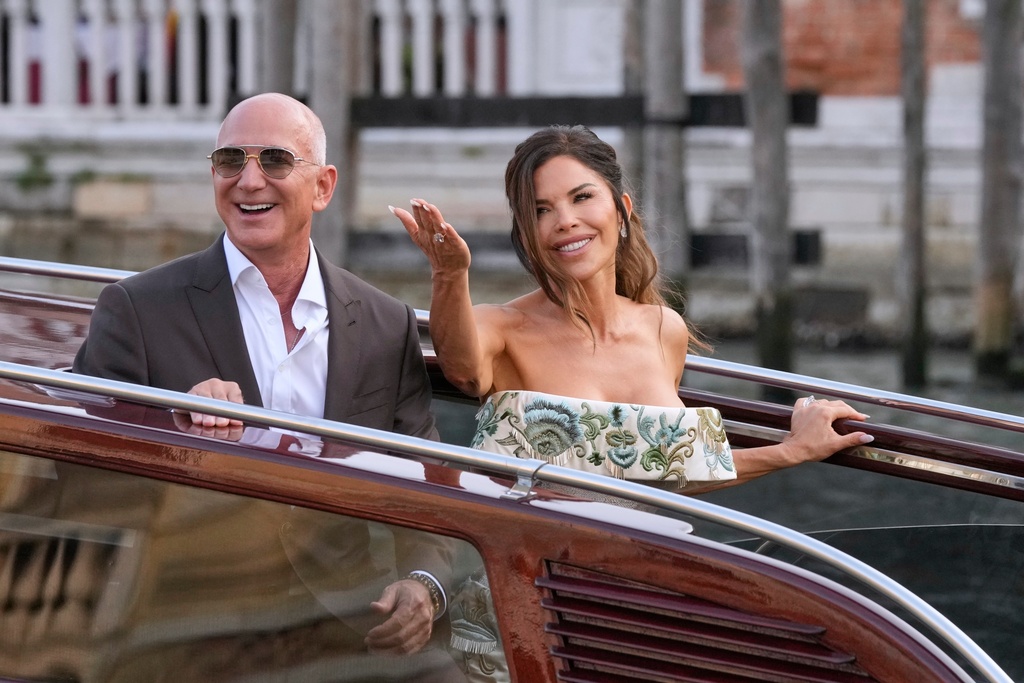 Jeff Bezos and Lauren Sanchez leave a hotel for their pre-wedding reception in Venice, Italy, June 26, 2025. (AP Photo/Luca Bruno, File)