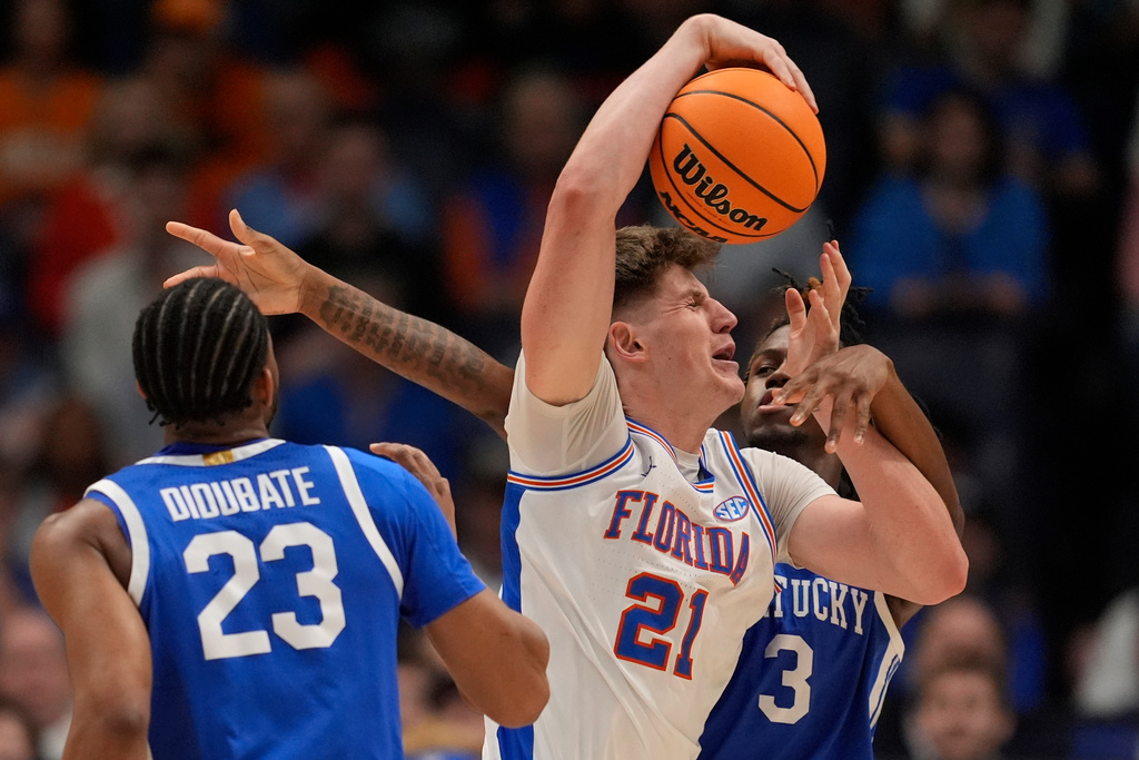 Florida forward Alex Condon (21) drives against Florida center Micah Handlogten (3) during the first half of an NCAA college basketball game in the quarterfinal round of the Southeastern Conference tournament, Friday, March 13, 2026, in Nashville, Tenn. (AP Photo/George Walker IV)