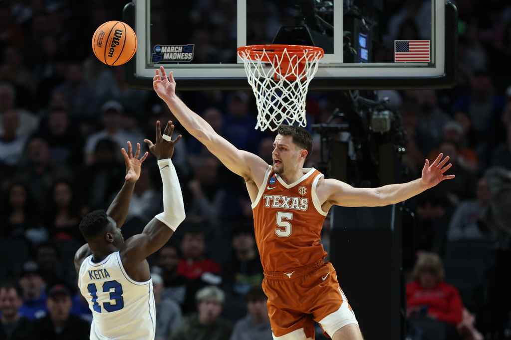 BYU center Keba Keita (13) shoots as Texas forward Camden Heide (5) defends during the first half in the first round of the NCAA college basketball tournament Thursday, March 19, 2026, in Portland, Ore. (AP Photo/Amanda Loman)