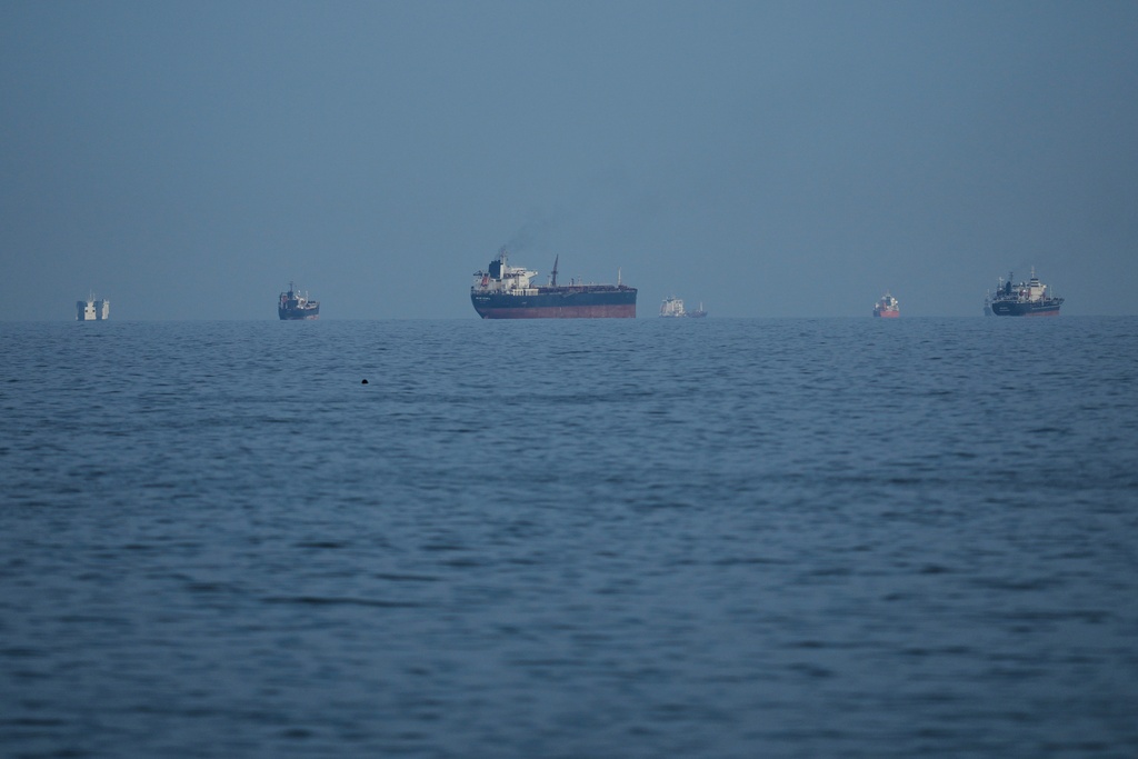 Oil tankers and cargo ships line up in the Strait of Hormuz as seen from Khor Fakkan, United Arab Emirates, Wednesday, March 11, 2026. (AP Photo/Altaf Qadri)