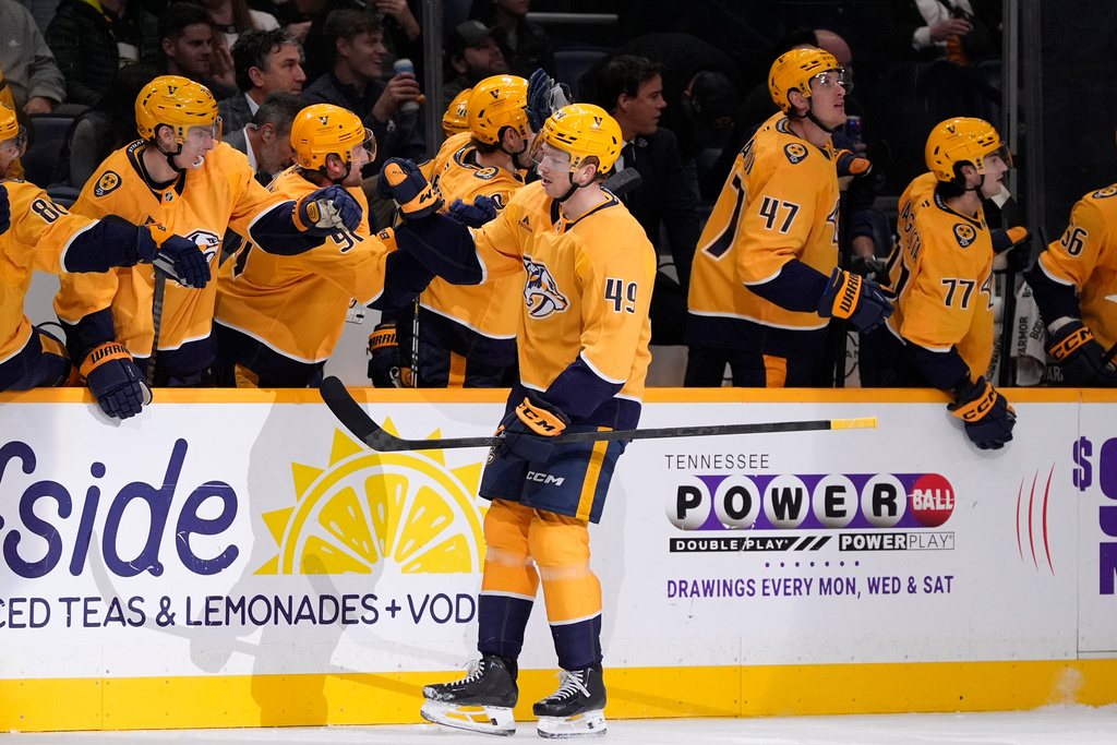 Nashville Predators left wing Reid Schaefer (49) celebrates his goal with teammates during the first period of an NHL hockey game against the Colorado Avalanche, Tuesday, Dec. 9, 2025, in Nashville, Tenn. (AP Photo/George Walker IV)
