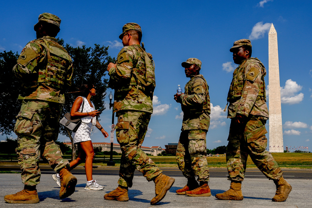 Members of the District of Columbia National Guard patrol along the National Mall, Saturday, Aug. 16, 2025, in Washington. (AP Photo/Julia Demaree Nikhinson)