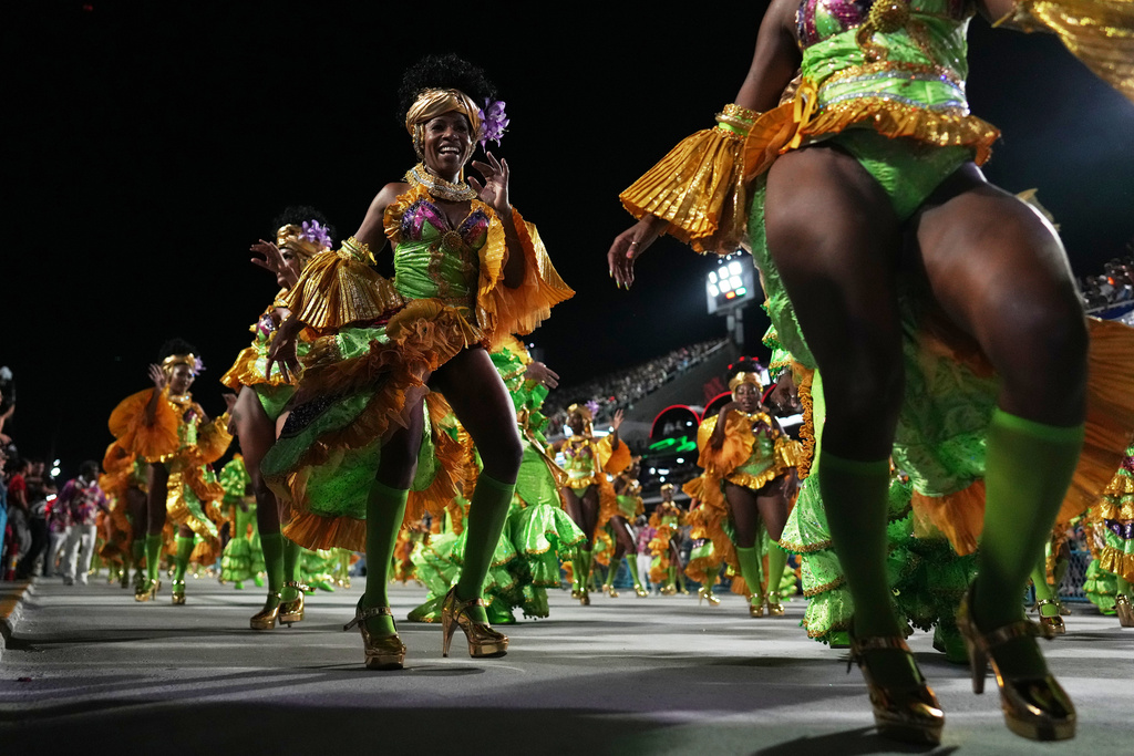 Performers from the Mocidade samba school parade during Carnival celebrations at the Sambadrome in Rio de Janeiro, Monday, Feb. 16, 2026. (AP Photo/Silvia Izquierdo)