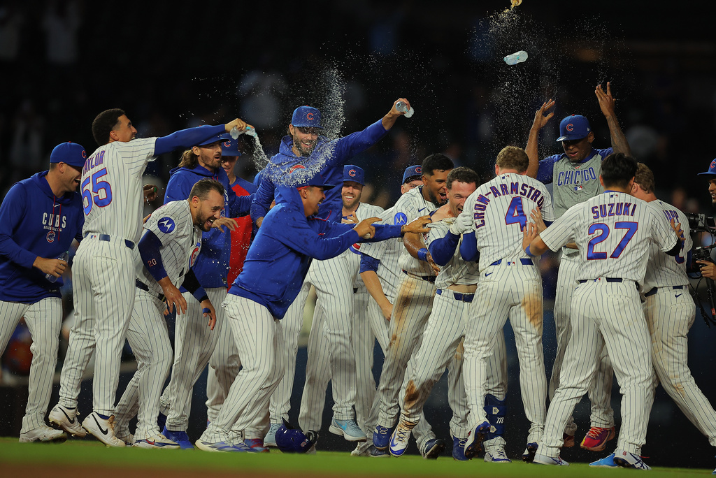 Chicago Cubs' Alex Bregman celebrates with his teammates after his game winning hit during the ninth inning of a baseball game against the Chicago White Sox, Tuesday, Aug. 18, 2026, in Chicago. (AP Photo/Melissa Tamez)