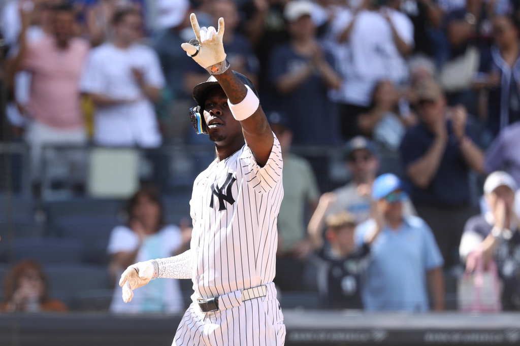 New York Yankees' Jazz Chisholm Jr. reacts after hitting a three-run home run, leading Trent Grisham and Anthony Volpe to also score, during the eighth inning of a baseball game against the Boston Red Sox, Sunday, June 7, 2026, in New York. (AP Photo/Pamela Smith)