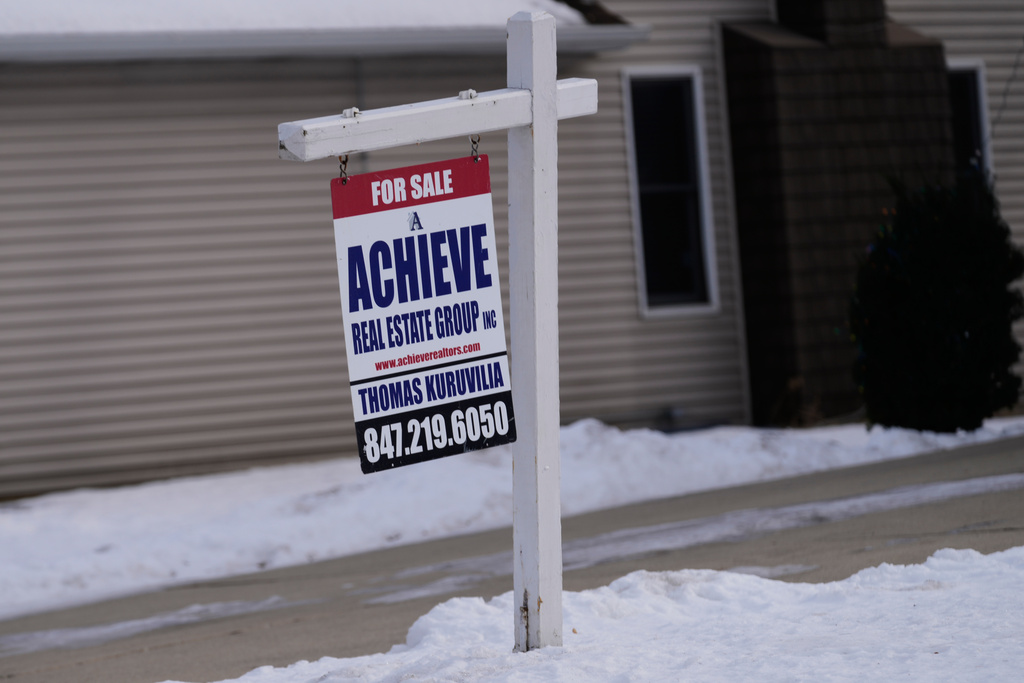 A "For Sale" sign is displayed in front of a home in Prospect Heights, Ill., Monday, Dec. 15, 2025. (AP Photo/Nam Y. Huh)