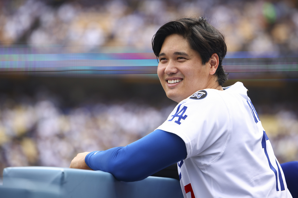 Los Angeles Dodgers' Shohei Ohtani reacts in the dugout during the third inning of a baseball game against the San Francisco Giants, Sunday, Sept. 21, 2025, in Los Angeles. (AP Photo/Jessie Alcheh)