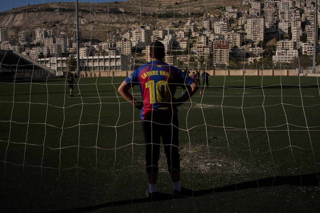 Wearing a Barcelona jersey bearing the name of Spanish soccer player Lamine Yamal, a Palestinian youth from a local soccer academy takes part in a training session at the municipal stadium in the West Bank city of Nablus, Thursday, May 7, 2026. (AP Photo/Leo Correa)