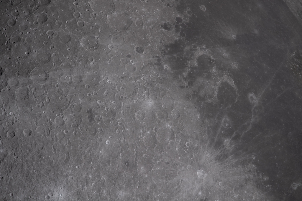 In this image provided by NASA, the Artemis II crew captured this image of the of Carroll Crater, a name suggested by the crew for Reid Wiseman late wife Carroll Taylor Wiseman on Monday, April 6, 2026. (NASA via AP)