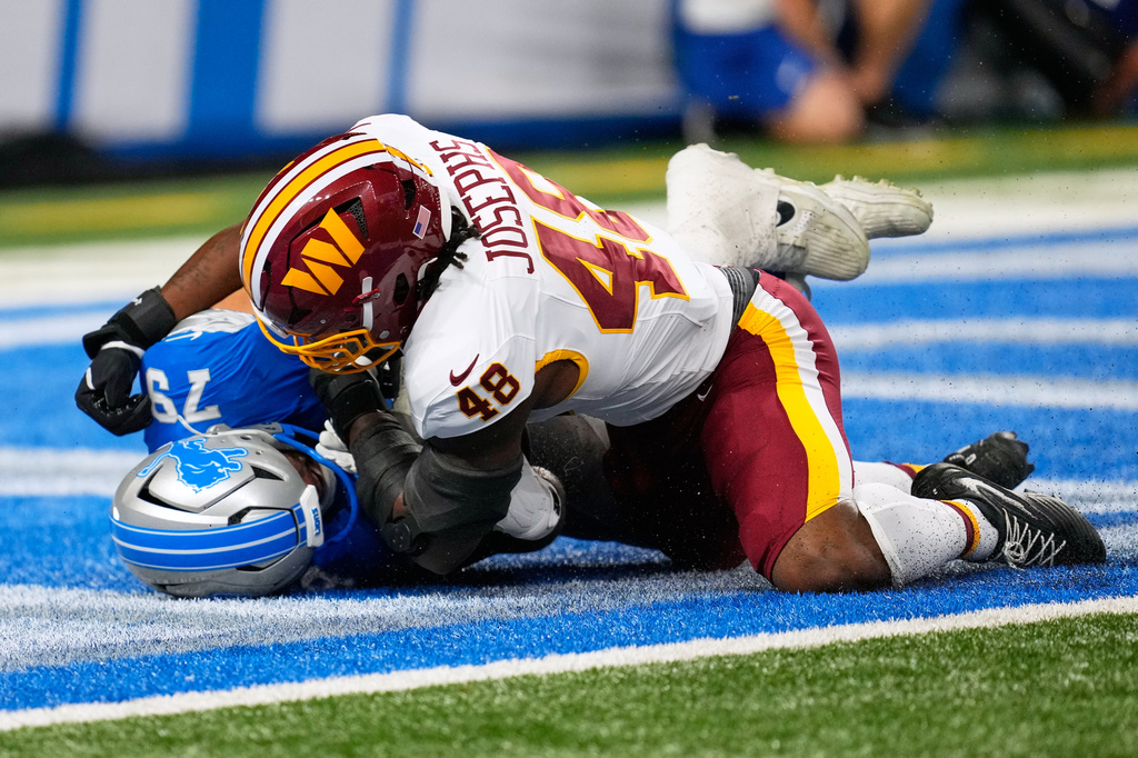 Washington Commanders Joshua Josephs (48) scores against Detroit Lions Foster Sarell during a preseason NFL football game, Saturday, Aug. 22, 2026, in Detroit. (AP Photo/Paul Sancya)
