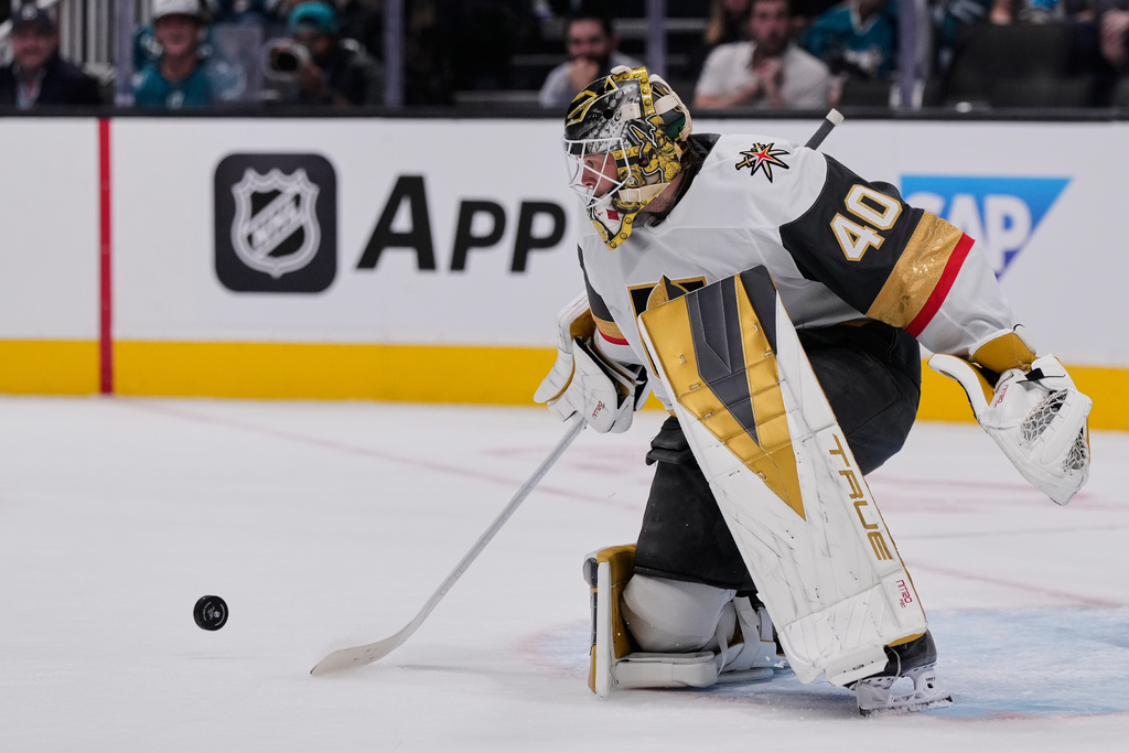 Vegas Golden Knights goaltender Akira Schmid (40) deflects a shot during the first period of an NHL hockey game against the San Jose Sharks, Thursday, Oct. 9, 2025, in San Jose, Calif. (AP Photo/Godofredo A. Vásquez)