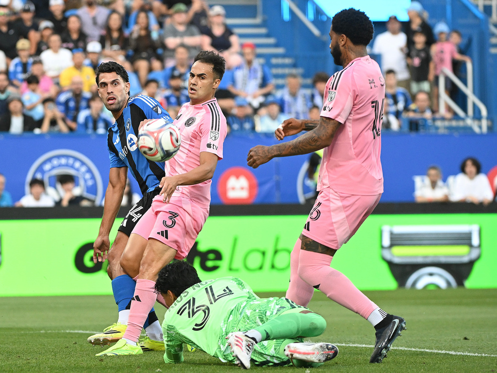 Inter Miami CF's Sergio Reguilon (3) and Micael Dos Santos Silva (16) defend as goalkeeper Rocco Rios Novo (34) comes out for the ball as CF Montreal's Daniel Rios, left, attempts a shot on goal during first half MLS soccer action in Montreal, on Saturday, July 25, 2026. (Graham Hughes/The Canadian Press via AP)