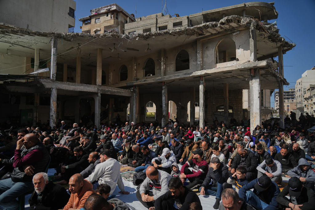 Muslim worshippers gather for Friday prayer during the holy fasting month of Ramadan at the Alkanz Mosque, which was damaged during the Israel–Hamas war, in Gaza City, Friday, Feb. 20, 2026. (AP Photo/Jehad Alshrafi)