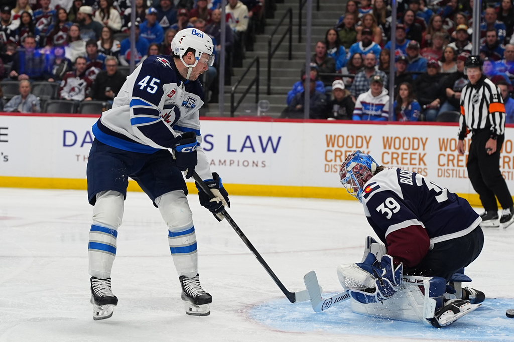Winnipeg Jets left wing Cole Koepke, left, scores against Colorado Avalanche goaltender MacKenzie Blackwood (39) in the second period of an NHL hockey game Saturday, March 28, 2026, in Denver. (AP Photo/David Zalubowski)