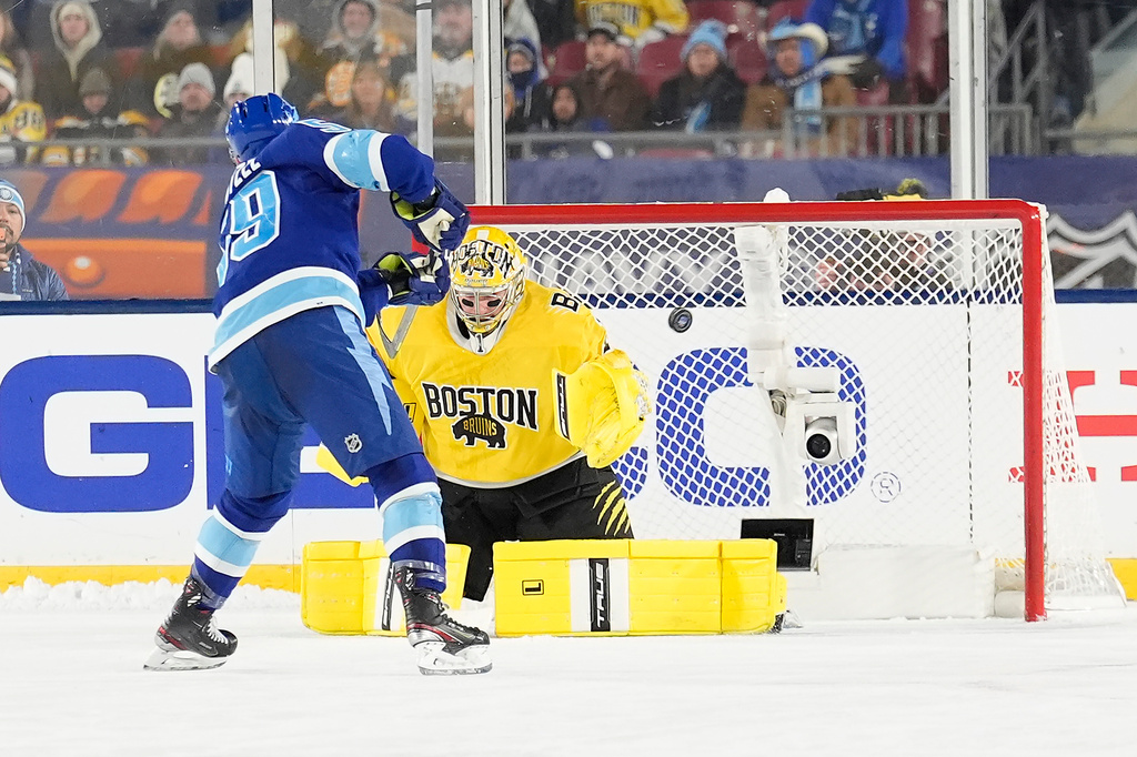 Tampa Bay Lightning center Jake Guentzel (59) scores past Boston Bruins goaltender Jeremy Swayman (1) during a shootout in a Stadium Series NHL hockey game Sunday, Feb. 1, 2026, in Tampa, Fla. (AP Photo/Chris O'Meara)