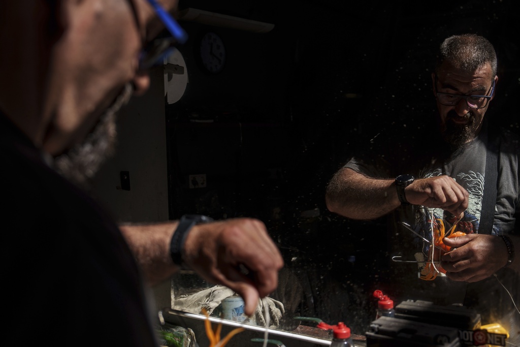 Octopus fisherman Juan Martinez demonstrates how to use the traditional octopus capture device his family has used for generations Thursday, June 26, 2025, in Cangas, Spain. (AP Photo/Annika Hammerschlag)