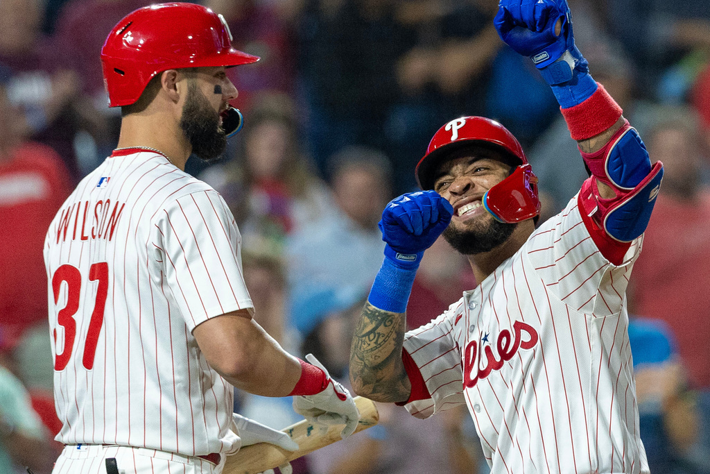 Philadelphia Phillies' Edmundo Sosa, right, celebrates with Weston Wilson (37) after hitting a two run homer in the fifth inning of a baseball game against the Miami Marlins, Wednesday, Sept. 24, 2025, in Philadelphia. (AP Photo/Laurence Kesterson)
