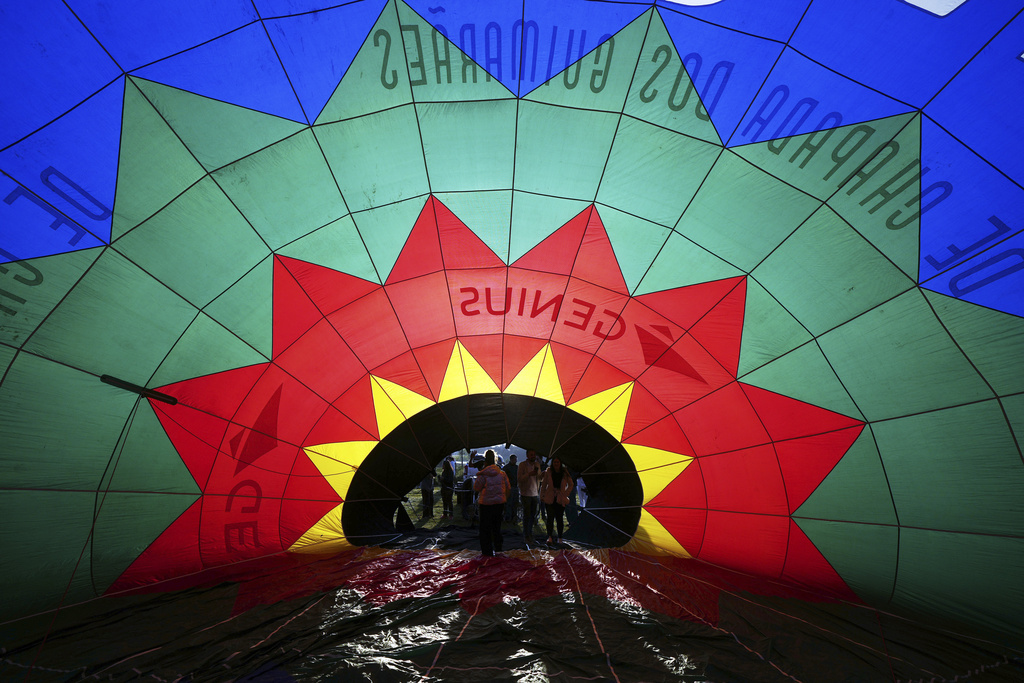 A hot air balloon is partially inflated as it is prepared for a World Ballooning Championships race in Colonia Yguazu, Paraguay, Friday, Aug. 29, 2025. (AP Photo/Jorge Saenz)