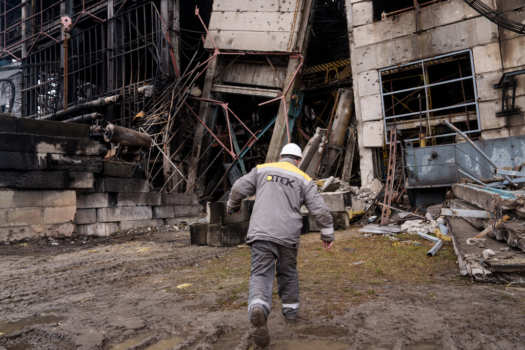 A worker walks in front of a production hall after a recent Russian missile attack at DTEK's power plant in Ukraine, on Wednesday, Dec. 10, 2025. (AP Photo/Evgeniy Maloletka)