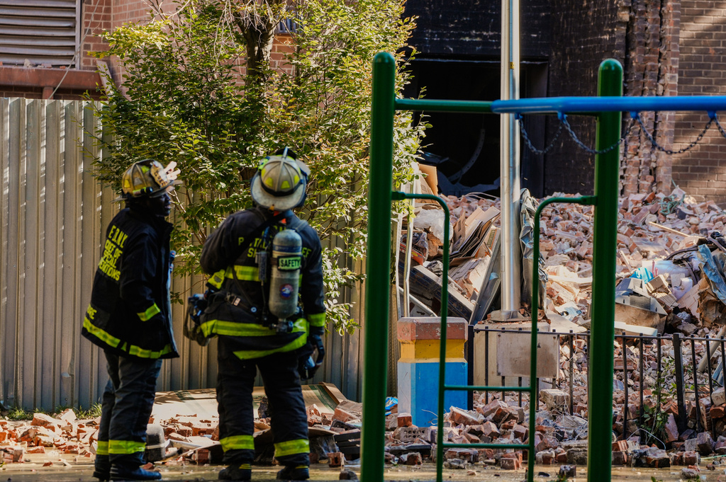 Firefighters work near the site of a building collapse in the Bronx borough of New York, Wednesday, Oct. 1, 2025. (AP Photo/Eduardo Munoz Alvarez)
