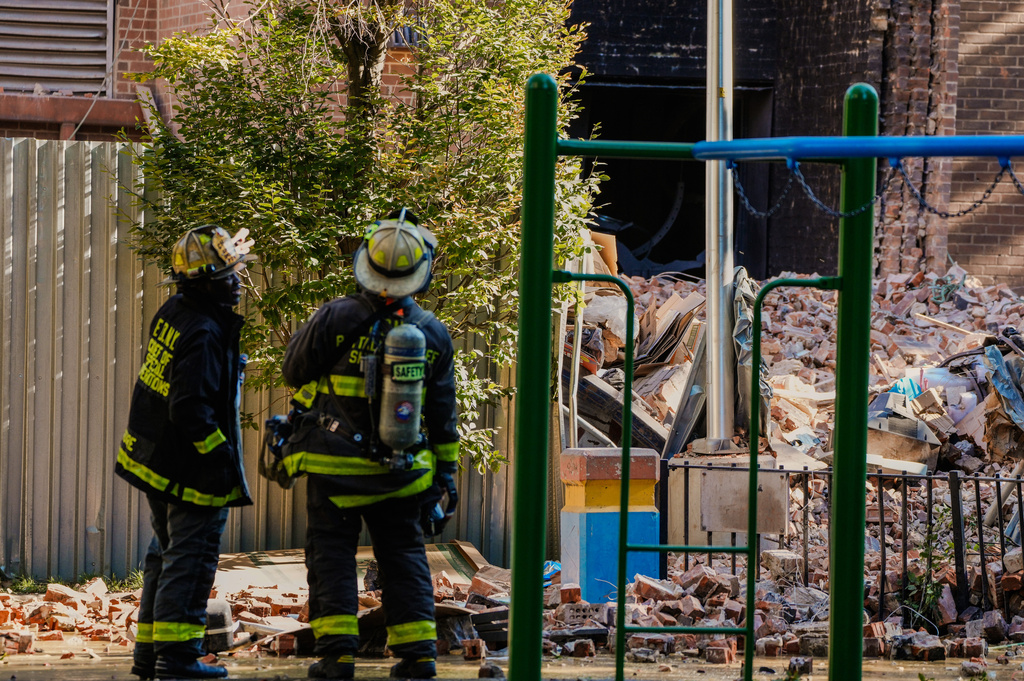 Firefighters work near the site of a building collapse in the Bronx borough of New York, Wednesday, Oct. 1, 2025. (AP Photo/Eduardo Munoz Alvarez)