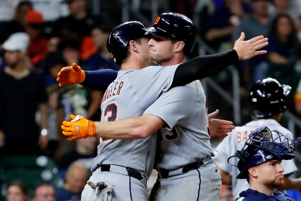 In a repeat of the third inning, Detroit Tigers' Dillon Dingler, center left, and Colt Keith, center right, hug at the plate after they both scored on the two-run home run by Keith against the Houston Astros during the seventh inning of a baseball game Monday, June 15, 2026, in Houston. (AP Photo/Michael Wyke)