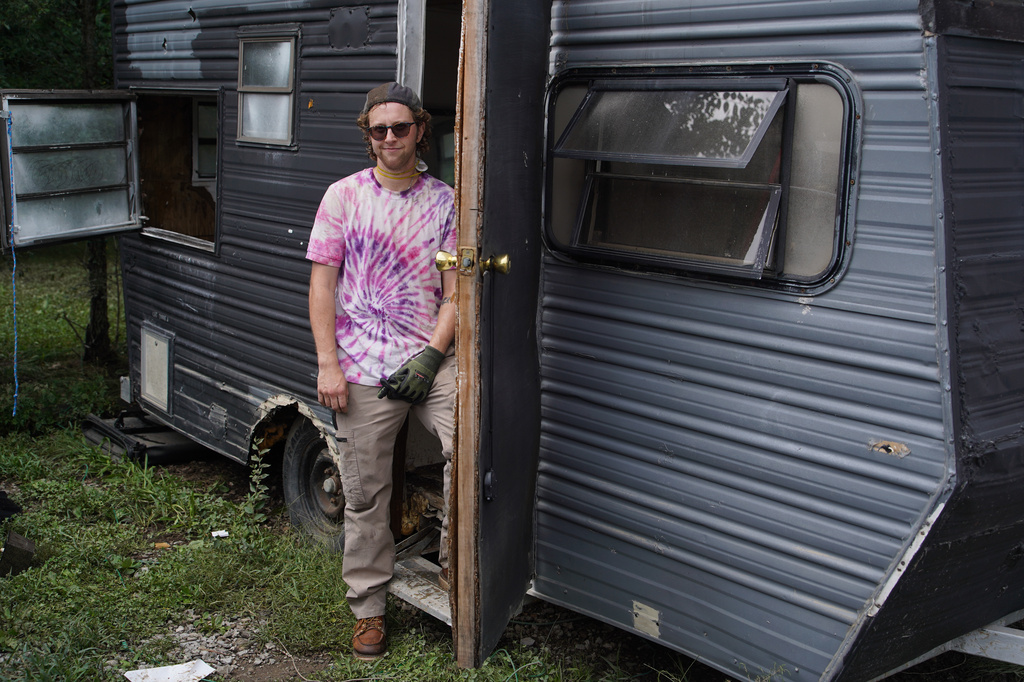 Oliver Riggle stands at the doorway of his flooded trailer in Indianapolis, Monday, Aug. 17, 2026. (AP Photo/Obed Lamy)