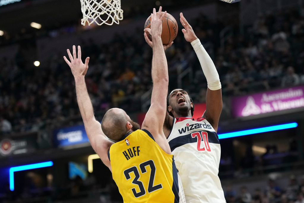 Washington Wizards center Alex Sarr (20) shoots over Indiana Pacers center Jay Huff (32) during the first half of an NBA Cup basketball game in Indianapolis, Friday, Nov. 28, 2025. (AP Photo/AJ Mast)