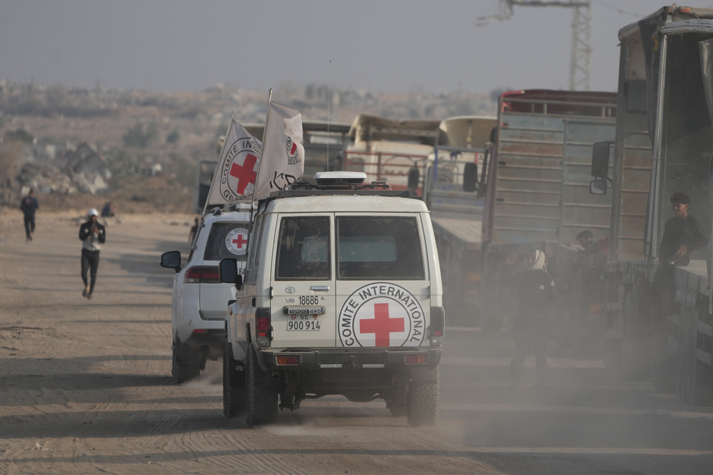 Red Cross convoy carrying what Hamas claims is the remains of an Israeli soldier who was killed in Gaza in 2014 and whose body has been held in Gaza since. makes its way toward the border crossing with Israel, to be transferred to Israeli authorities, in Deir al-Balah, Gaza Strip, Sunday, Nov. 9, 2025. (AP Photo/Jehad Alshrafi)