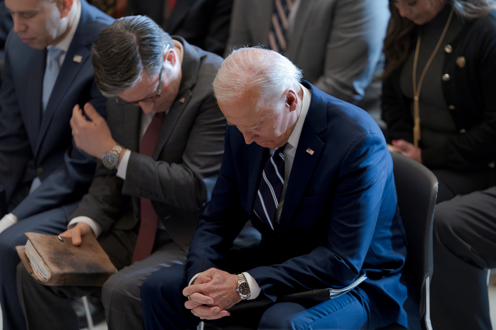 FILE- President Joe Biden, with from left, House Minority Leader Hakeem Jeffries, D-N.Y., and House Speaker Mike Johnson of La., pray and listen during the National Prayer Breakfast, Feb. 1, 2024, at the Capitol in Washington. (AP Photo/J. Scott Applewhite, File)