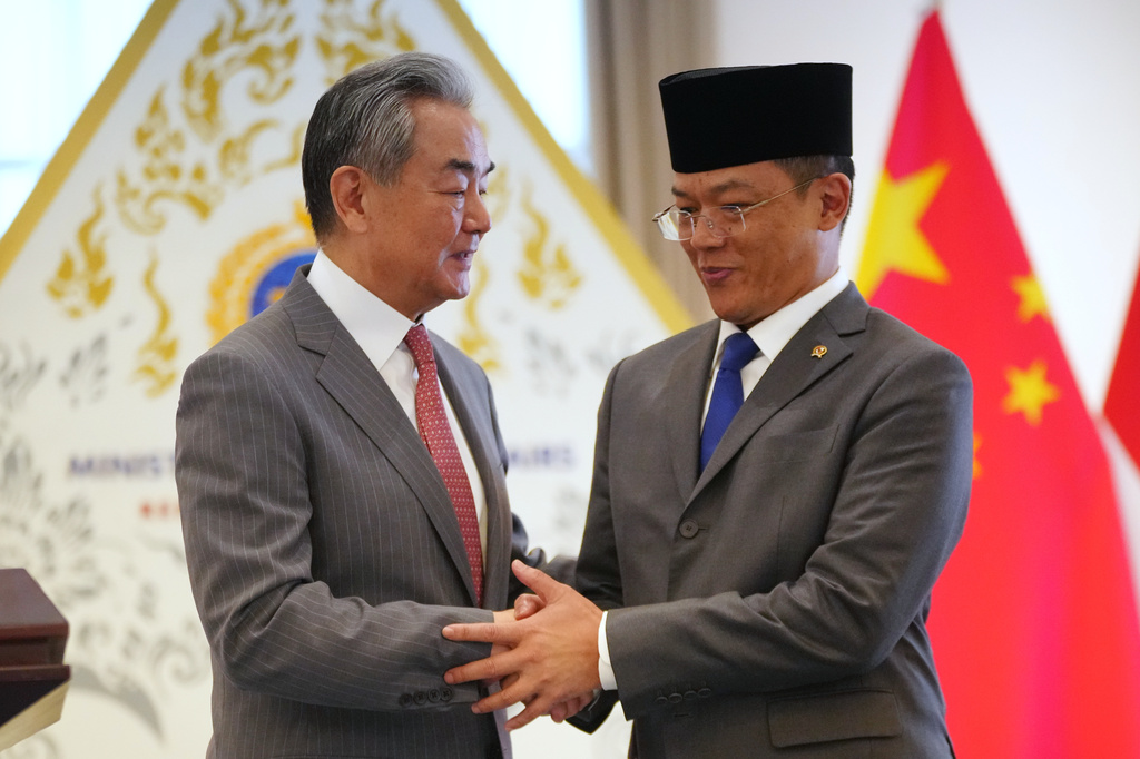 China's Foreign Minister Wang Yi, left, shakes hands with his Indonesian counterpart Sugiono during a joint press conference after the Comprehensive Strategic Dialogue between Indonesia and China in Jakarta, Indonesia, Friday, Aug. 21, 2026. (AP Photo/Tatan Syuflana)