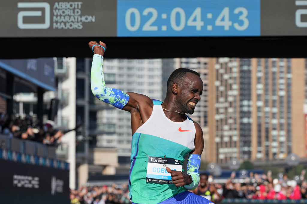 Addisu Gobena of Ethiopia reacts as he crosses the finish line at the Opera House to win the Sydney Marathon, in Sydney, Sunday, Aug. 30, 2026. (AP Photo/Mark Baker)
