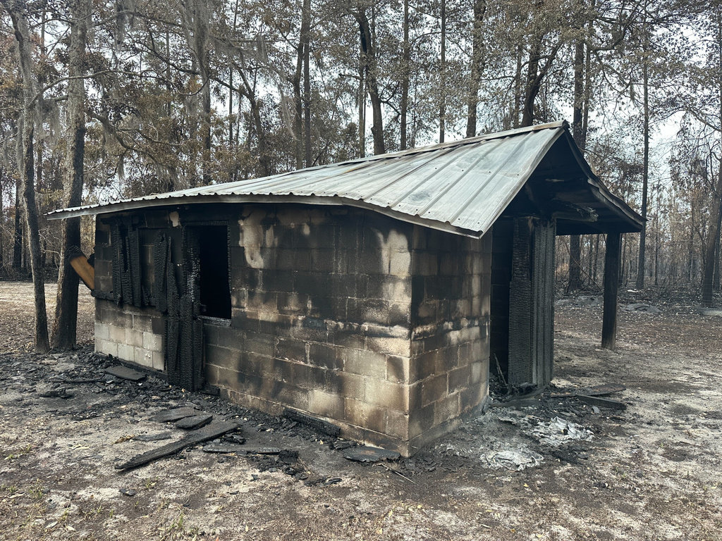 A charred cinderblock shed stands near the Waynesville community in Brantley County, Ga., on Monday, April 27, 2026. (AP Photo/Russ Bynum)