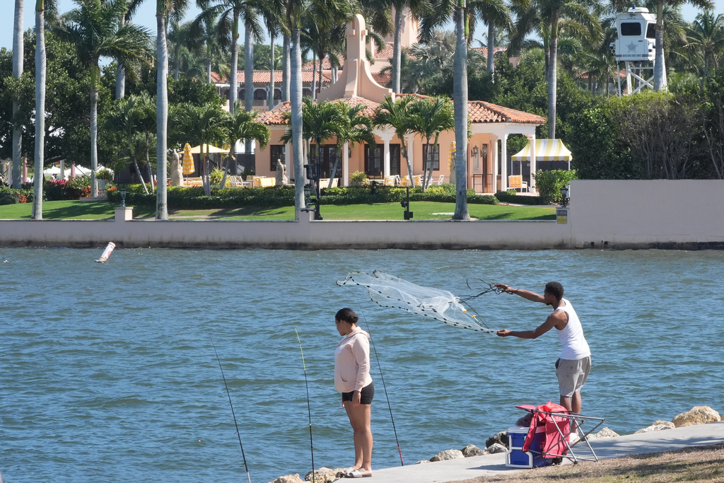 A fisherman casts his neat near Mar-a-Lago Sunday, Feb. 22, 2026, in Palm Beach, Fla. The U.S. Secret Service announced Sunday that an armed man was shot and killed after entering the secure perimeter of Mar-a-Lago, President Donald Trump's resort. (AP Photo/Marta Lavandier)