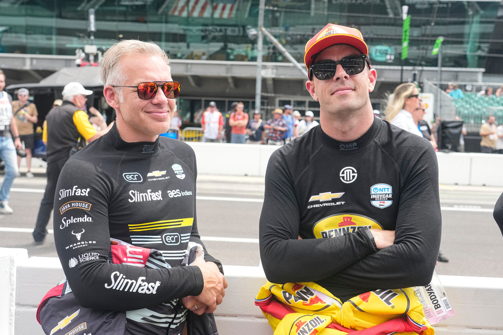 Ed Carpenter, left, talks with Scott McLaughlin before practice for the Indianapolis 500 auto race at the Indianapolis Motor Speedway in Indianapolis, Monday, May 18, 2026. (AP Photo/Michael Conroy)