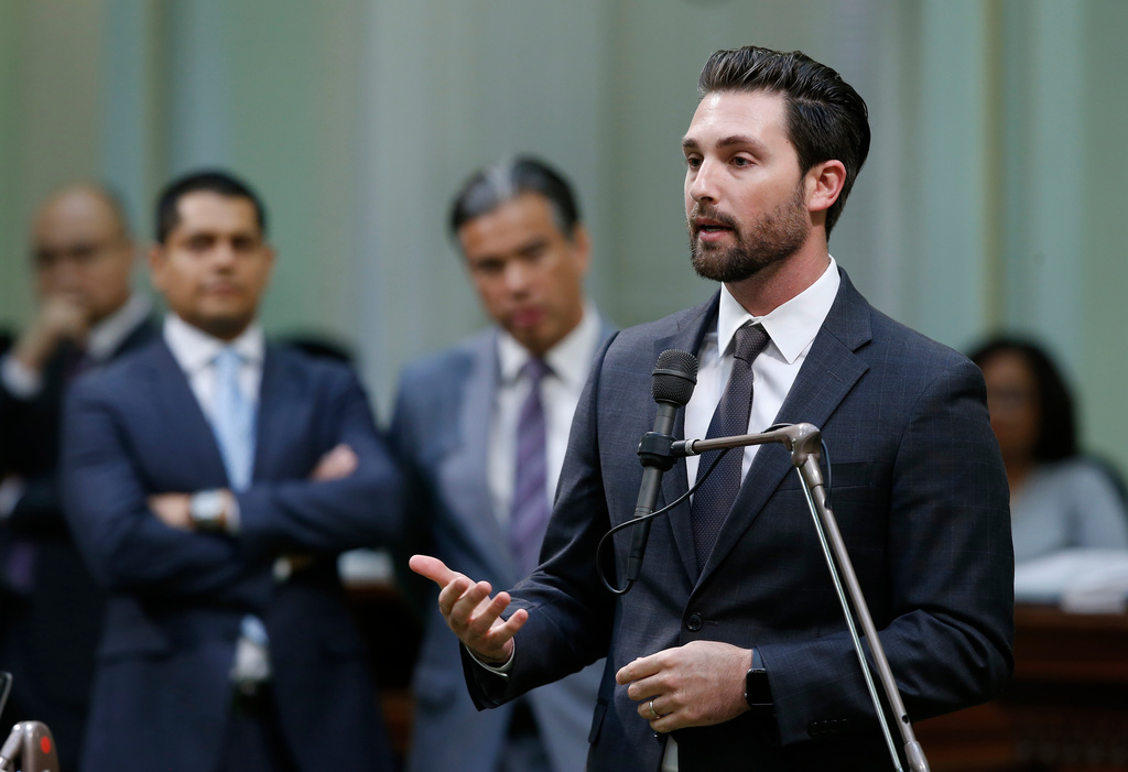 FILE - Assemblyman Ian Calderon, D-Whittier, urges lawmakers to approve a measure to give new wage and benefit protections at the so-called gig economy companies like Uber and Lyft, during the Assembly session in Sacramento, Calif., Sept. 11, 2019. (AP Photo/Rich Pedroncelli, File)