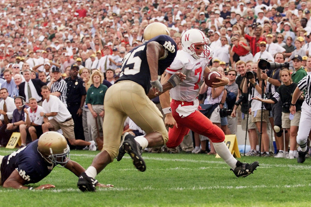 FILE - Nebraska quarterback Eric Crouch runs for the winning touchdown in overtime as Notre Dame's Tony Driver, center, and Brock Williams, left, attempt a tackle, Sept. 9, 2000, in South Bend, Ind. (AP Photo/Ted S. Warren, File)