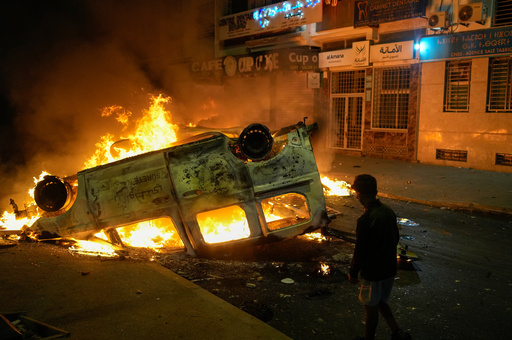 A boy stands next to a torched police vehicle as youth led protests calling for healthcare and education reforms turned violent, in Sale, Morocco, Wednesday, Oct. 1, 2025. (AP Photo/Mosa'ab Elshamy) A boy stands next to a torched police vehicle as youth led protests calling for healthcare and education reforms turned violent, in Sale, Morocco, Wednesday, Oct. 1, 2025. (AP Photo/Mosa'ab Elshamy)