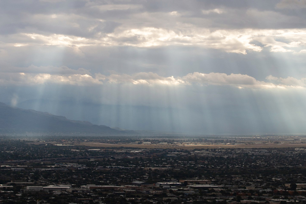 Rays of sunlight shine on the Davis-Monthan Air Force Base in Tucson, Ariz., between rain showers Tuesday, Sept. 29, 2026. (Mason Kumet/Arizona Luminaria via AP)