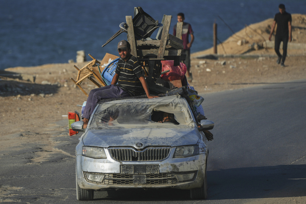 Displaced Palestinians fleeing northern Gaza carry their belongings in a car along the coastal road toward southern Gaza, Friday, Sept. 5, 2025. (AP Photo/Jehad Alshrafi)