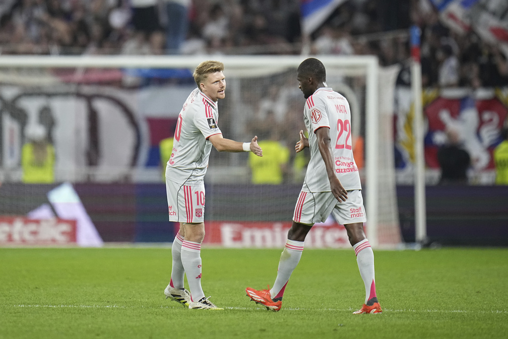 Lyon's Pavel Sulc, left, and Lyon's Clinton Mata celebrate after scoring during the French League One soccer match between Olympique Lyon and Angers at Groupama stadium in Decines, outside Lyon, France, Friday, Sept. 19, 2025. (AP Photo/Laurent Cipriani)