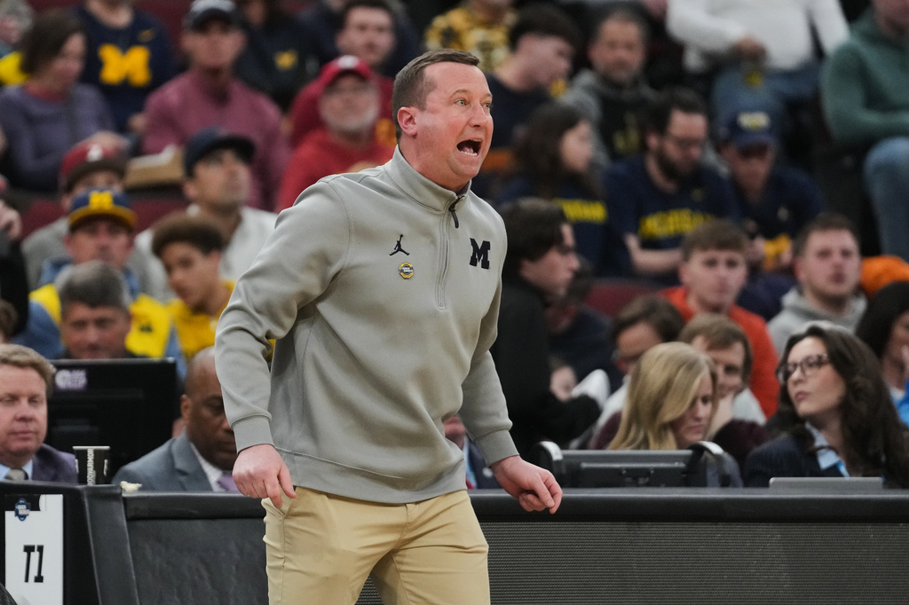 Assistant coach Kyle Churchis seen on the sidelines during the first half in the Sweet 16 of the NCAA college basketball tournament against Alabama, Friday, March 27, 2026, in Chicago. (AP Photo/Erin Hooley) CORRECTION: Name corrected to Assistant coach Kyle Churchis instead Michigan head coach Dusty May.
