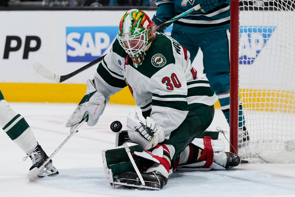 Minnesota Wild goaltender Jesper Wallstedt (30) stops a shot during the third period of an NHL hockey game against the San Jose Sharks, Wednesday, Dec. 31, 2025, in San Jose, Calif. (AP Photo/Godofredo A. V&aacute;squez)