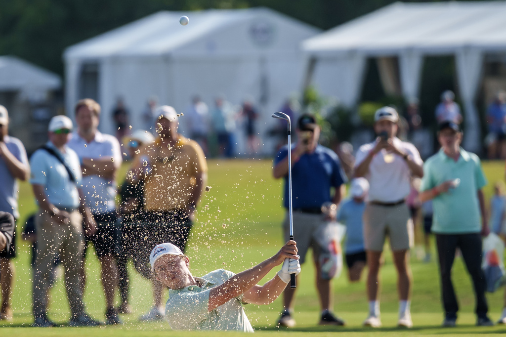 Matt Fitzpatrick, of England, hits a bunker shot close to the 18th hole to set up a birdie putt by his brother Alex Fitzpatrick and winning the final round of the PGA Zurich Classic of New Orleans golf tournament, Sunday, April 26, 2026, in Avondale, La. (AP Photo/Matthew Hinton)