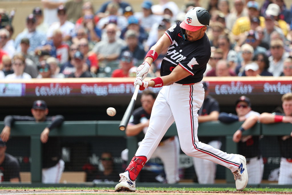 Minnesota Twins' Trevor Larnach hits a two RBI double against the Chicago White Sox during the first inning of a baseball game, Sunday, Aug. 30, 2026, in Minneapolis. (AP Photo/Matt Krohn)