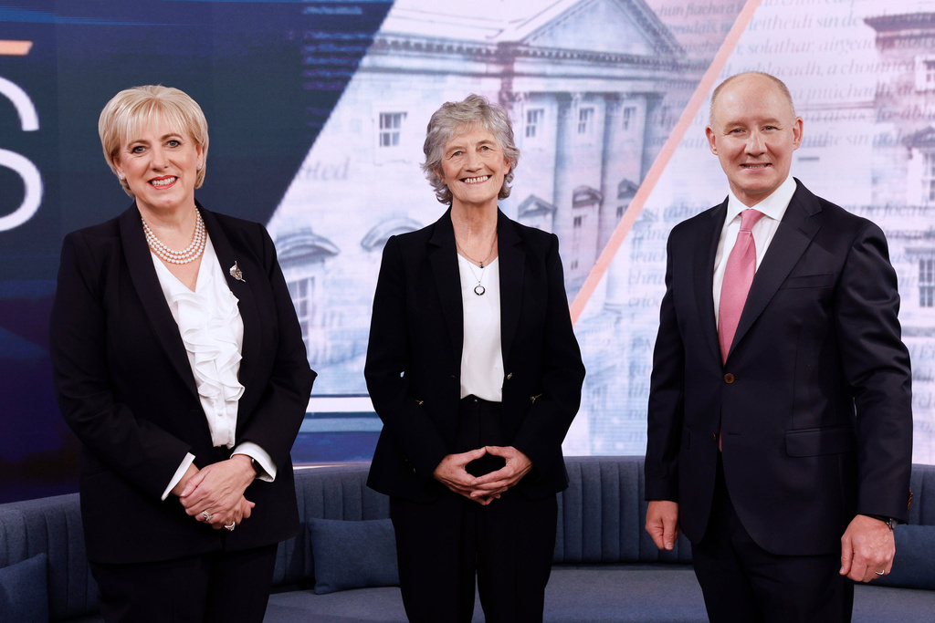 Irish presidential candidates, from left, Fine Gael's candidate Heather Humphreys, independent candidate Catherine Connolly, who is backed by Sinn Fein and Fianna Fail candidate Jim Gavin, pose for a photo during a debate on The Week in Politics at RTE studios in Donnybrook, Dublin, Sunday, Oct. 5, 2025. (Conor O'Mearain/PA via AP)